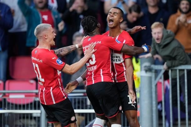 Cody Gakpo of PSV celebrates 3-0 with Philipp Max of PSV, Noni Madueke of PSV during the UEFA Champions League match between PSV v FC Midtjylland at...