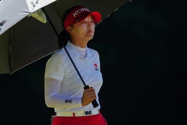 South Korea's Ko Jin Young stands under an umbrella as she waits to tee off from the 17th tee in round 2 of the womens golf individual stroke play...