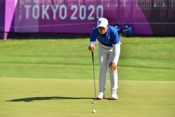 Philippines' Yuka Saso sets up her putt on the 18th green in round 2 of the womens golf individual stroke play during the Tokyo 2020 Olympic Games at...