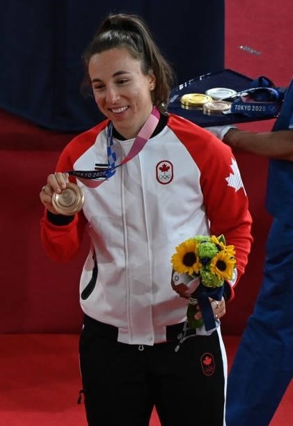 Bronze medallist Canada's Lauriane Genest poses with her medal after the women's track cycling keirin final during the Tokyo 2020 Olympic Games at...