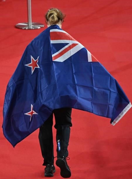 Silver medallist New Zealand's Ellesse Andrews wears a flag over her shoulders after the women's track cycling keirin final during the Tokyo 2020...