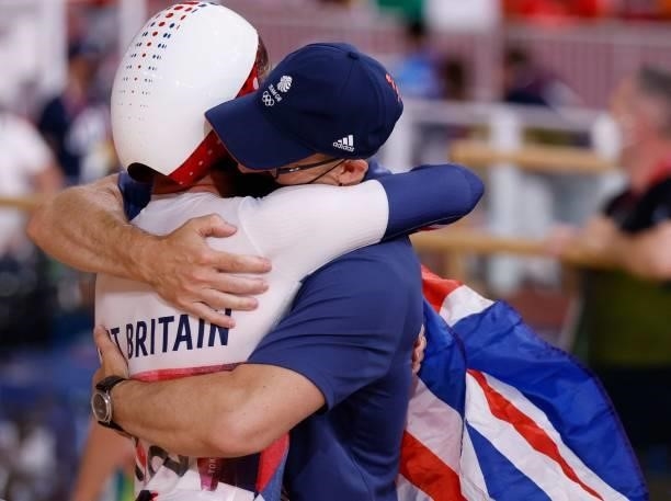 Britain's Matthew Walls celebrates with a member of his coaching team after winning the men's track cycling omnium points race during the Tokyo 2020...