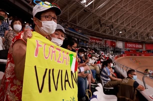 Supporter of Italy's Elia Viviani holds a sign as he competes in the men's track cycling omnium points race during the Tokyo 2020 Olympic Games at...