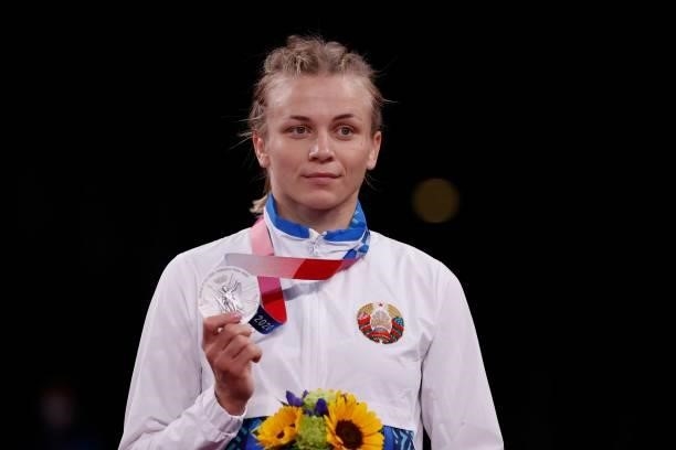 Silver medalist Belarus' Iryna Kurachkina poses with her medal on the podium after the women's freestyle 57kg wrestling competition of the Tokyo 2020...
