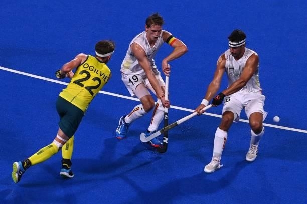 Australia's Flynn Andrew Ogilvie strikes the ball past Belgium's Felix Veronique Denayer and Alexander Robby Hendrickx during the men's gold medal...