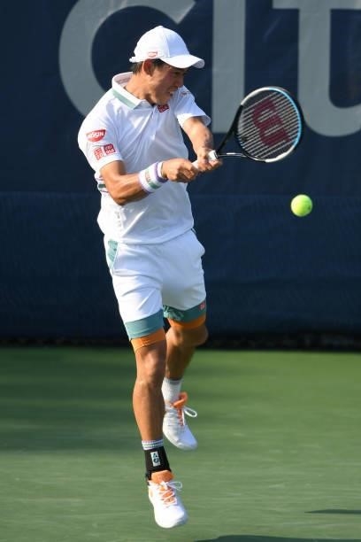 Kei Nishikori of Japan returns a shot during a match against Cameron Norrie of Great Britain on Day 6 during the Citi Open at Rock Creek Tennis...