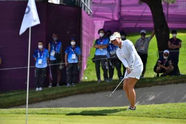 Denmark's Nanna Koerstz Madsen plays out of the rough by the side of the 18th green in round 3 of the womens golf individual stroke play during the...