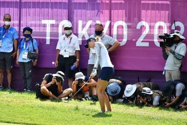 S Nelly Korda plays out of the rough by the side of the 18th green in round 3 of the womens golf individual stroke play during the Tokyo 2020 Olympic...