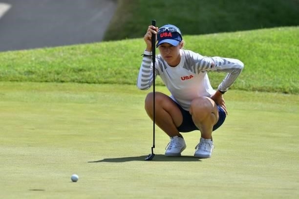 S Nelly Korda sets up her putt on the 18th green in round 3 of the womens golf individual stroke play during the Tokyo 2020 Olympic Games at the...