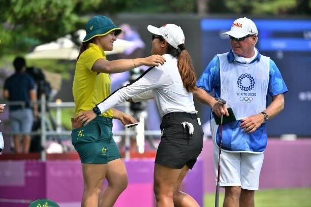 Australia's Hannah Green hugs China's Lin Xiyu after round 3 of the womens golf individual stroke play during the Tokyo 2020 Olympic Games at the...