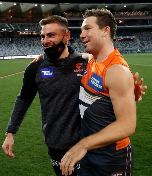 Stephen Coniglio and Toby Greene of the Giants celebrate during the 2021 AFL Round 21 match between the Geelong Cats and the GWS Giants at GMHBA...