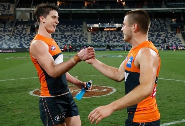 Sam Taylor and Xavier O'Halloran of the Giants celebrate during the 2021 AFL Round 21 match between the Geelong Cats and the GWS Giants at GMHBA...