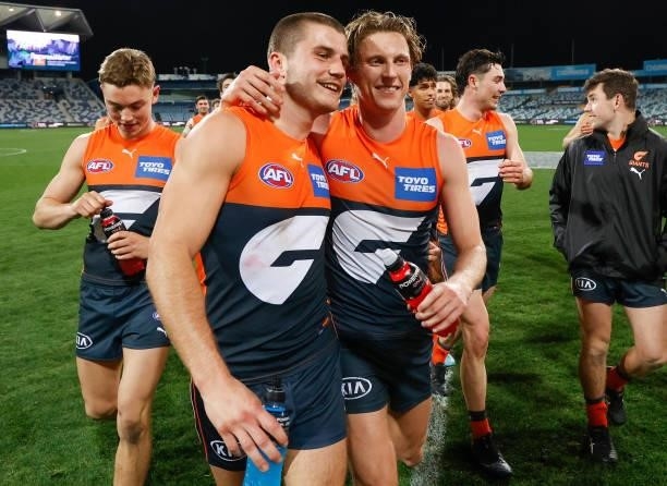 Xavier O'Halloran and Lachie Whitfield of the Giants celebrate during the 2021 AFL Round 21 match between the Geelong Cats and the GWS Giants at...