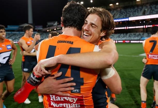 Tim Taranto and James Peatling of the Giants celebrate during the 2021 AFL Round 21 match between the Geelong Cats and the GWS Giants at GMHBA...