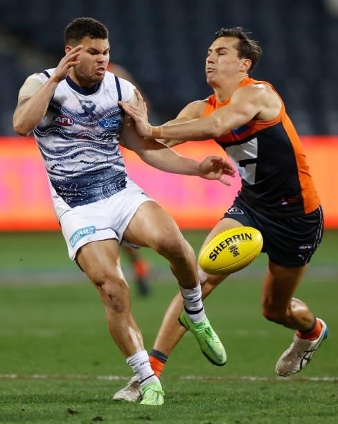 Brandan Parfitt of the Cats and Isaac Cumming of the Giants in action during the 2021 AFL Round 21 match between the Geelong Cats and the GWS Giants...