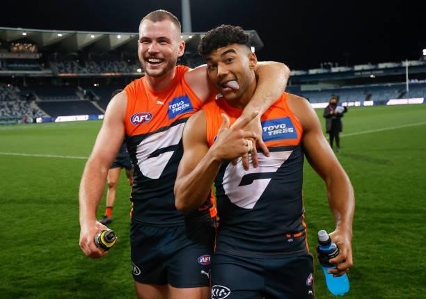 Kieren Briggs and Callum M. Brown of the Giants celebrate during the 2021 AFL Round 21 match between the Geelong Cats and the GWS Giants at GMHBA...