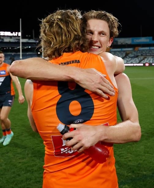Callan Ward and Lachie Whitfield of the Giants celebrate during the 2021 AFL Round 21 match between the Geelong Cats and the GWS Giants at GMHBA...