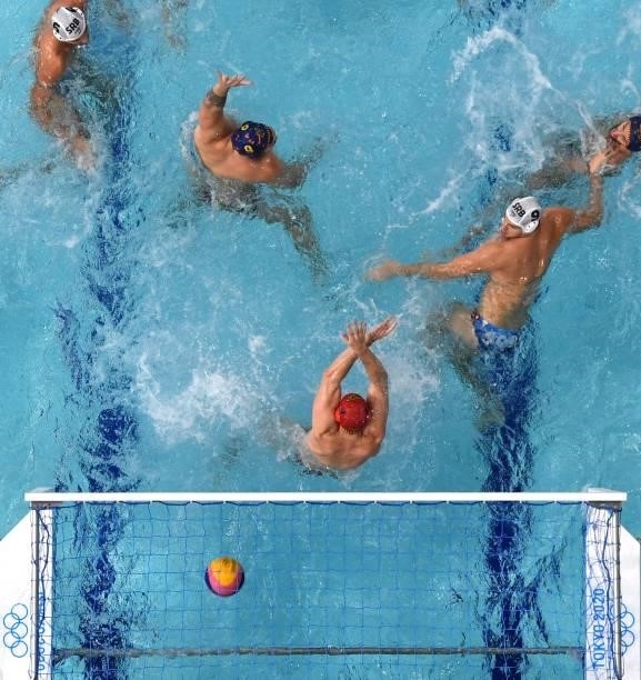 An overview shows Spain's goalkeeper Daniel Lopez Pinedo conceding a goal during the Tokyo 2020 Olympic Games men's water polo semi-final match...
