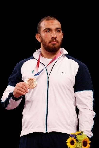 Bronze medalist Iran's Amir Hossein Zare poses with his medal on the podium after the men's freestyle 125kg wrestling competition during the Tokyo...