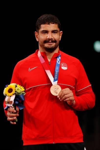 Bronze medalist Iran's Turkey's Taha Akgul poses with his medal on the podium after the men's freestyle 125kg wrestling competition during the Tokyo...