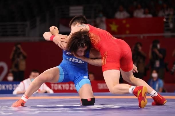 China's Pang Qianyu wrestles Japan's Mayu Mukaida in their women's freestyle 53kg wrestling final match during the Tokyo 2020 Olympic Games at the...