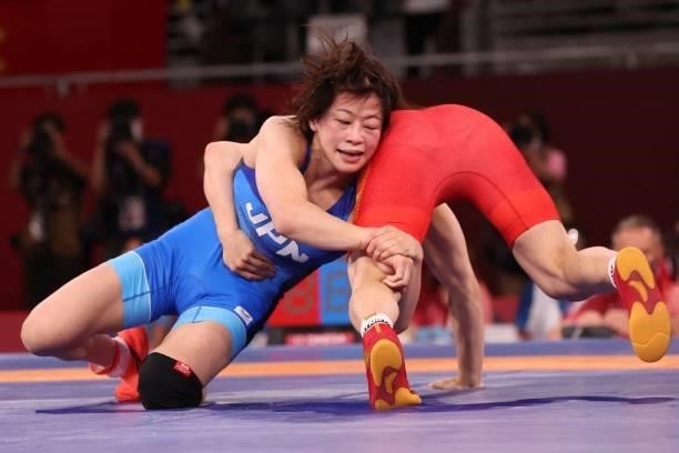 Japan's Mayu Mukaida wrestles China's Pang Qianyu in their women's freestyle 53kg wrestling final match during the Tokyo 2020 Olympic Games at the...