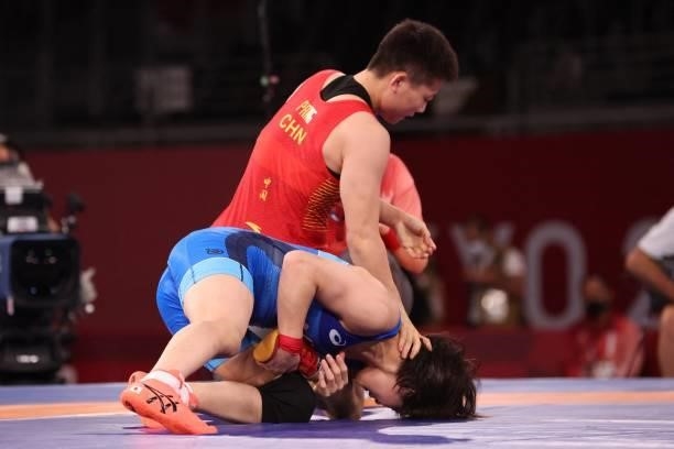 Japan's Mayu Mukaida wrestles China's Pang Qianyu in their women's freestyle 53kg wrestling final match during the Tokyo 2020 Olympic Games at the...
