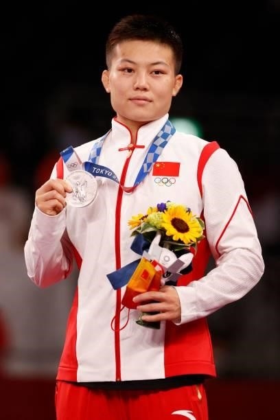 Silver medalist China's Pang Qianyu poses with her medal on the podium after the women's freestyle 53kg wrestling competition during the Tokyo 2020...