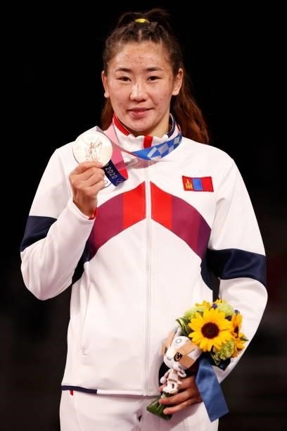 Bronze medalist Mongolia's Bolortuya Bat-Ochir poses with her medal on the podium after the women's freestyle 53kg wrestling competition during the...