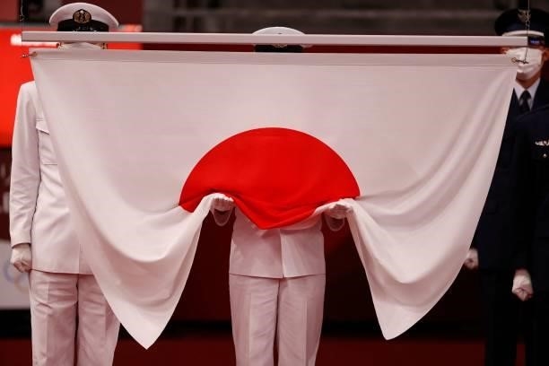The national flag of Japan is prepared to be raised before the medal ceremony after the women's freestyle 53kg wrestling competition during the Tokyo...