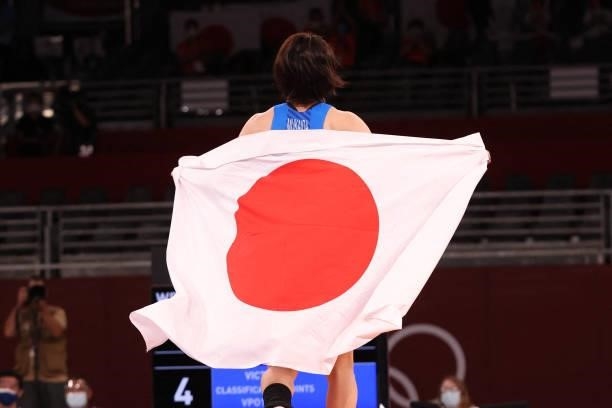 Japan's Mayu Mukaida celebrates her gold medal victory against China's Pang Qianyu after their women's freestyle 53kg wrestling final match during...