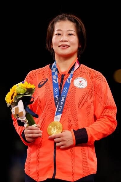 Gold medalist Japan's Mayu Mukaida poses with her medal on the podium after the women's freestyle 53kg wrestling competition during the Tokyo 2020...