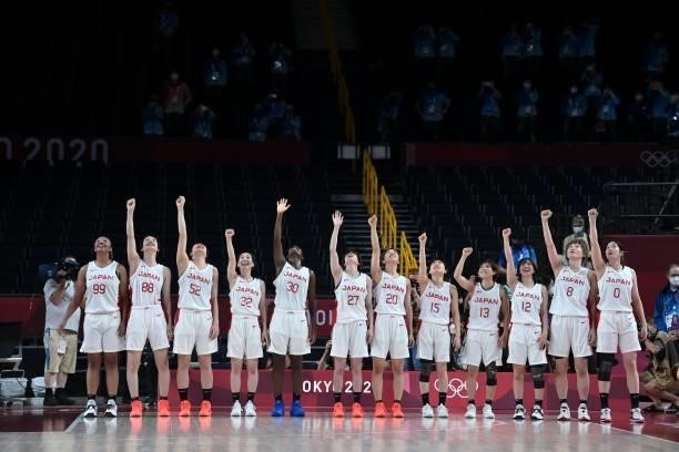Japan's players celebrate their victory at the end of the women's semi-final basketball match between Japan and France during the Tokyo 2020 Olympic...