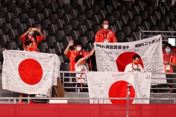 Supporters of gold medalist Japan's Mayu Mukaida cheer during the medal ceremony after the women's freestyle 53kg wrestling competition during the...