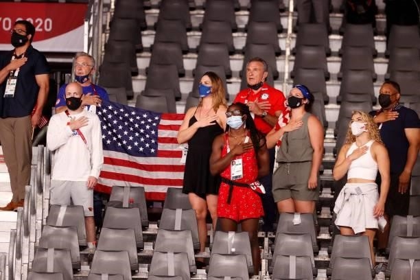 Supporters of USA's Gable Dan Steveson listen to the national anthem as the United States of America flag is raised during the medal ceremony after...
