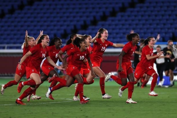 Players of Team Canada celebrate following their team's victory in the penalty shoot out in the Women's Gold Medal Match between Canada and Sweden on...