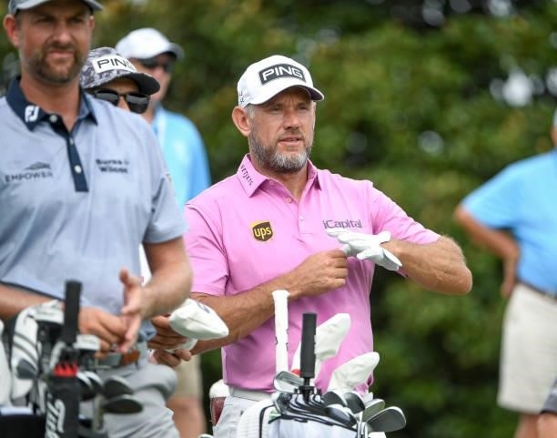 Lee Westwood of England removes his glove after hitting his tee shot at the 10th tee during the second round of the World Golf Championships-FedEx...