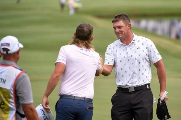 Bryson DeChambeau shakes hands with Cameron Smith of Australia at the 18th green during the second round of the World Golf Championships-FedEx St....