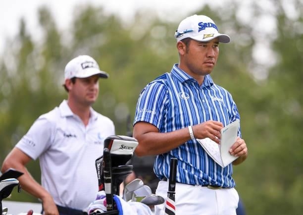 Hideki Matsuyama of Japan holds his yardage book while looking down the fairway at the 16th hole during the second round of the World Golf...