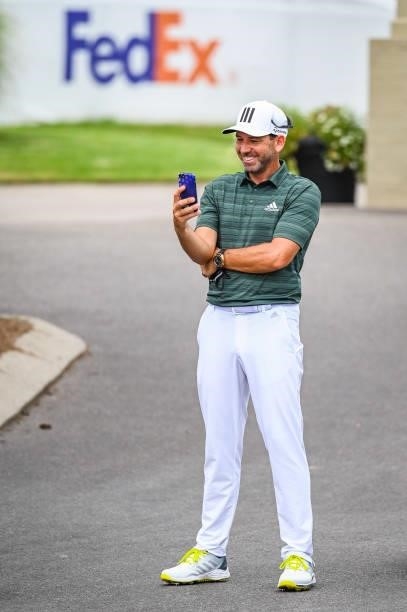 Sergio Garcia of Spain smiles while making a phone call following the second round of the World Golf Championships-FedEx St. Jude Invitational at TPC...