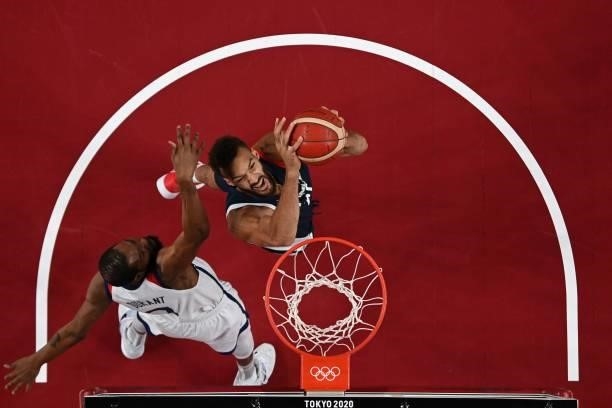 France's Rudy Gobert goes for a dunk past USA's Kevin Wayne Durant in the men's final basketball match between France and USA during the Tokyo 2020...