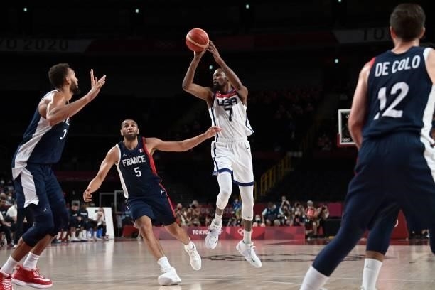 S Kevin Wayne Durant takes a shot past France's Nicolas Batum in the men's final basketball match between France and USA during the Tokyo 2020...