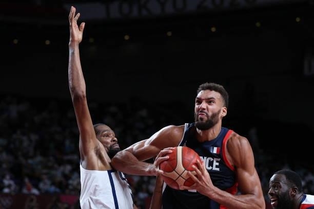 France's Rudy Gobert handles the ball past USA's Kevin Wayne Durant in the men's final basketball match between France and USA during the Tokyo 2020...