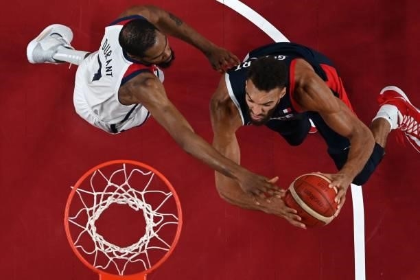 France's Rudy Gobert goes to the basket past USA's Kevin Wayne Durant in the men's final basketball match between France and USA during the Tokyo...