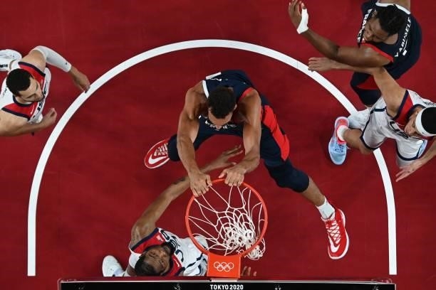 France's Rudy Gobert dunks the ball past USA's Kevin Wayne Durant in the men's final basketball match between France and USA during the Tokyo 2020...