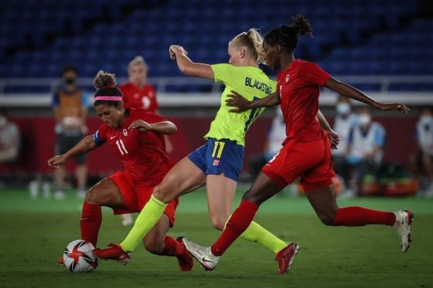 Stina BLACKSTENIUS of Team Sweden competes for the ball with Desiree SCOTT of Team Canada during the match between Sweden and Canada on day...