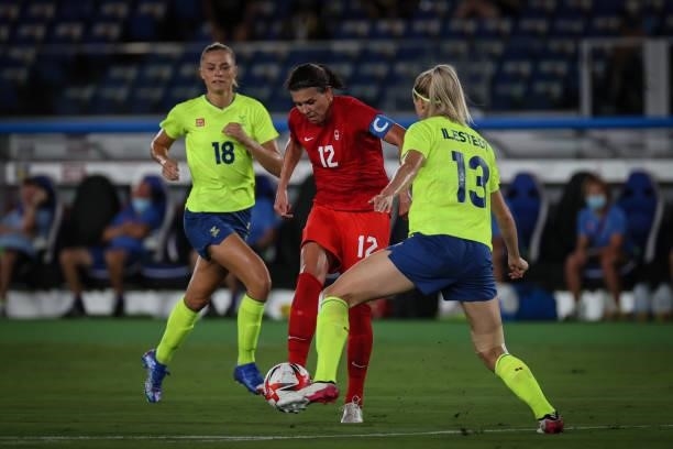 Amanda ILESTEDT of Team Sweden competes for the ball with Christine SINCLAIR of Team Canada during the match between Sweden and Canada on day...
