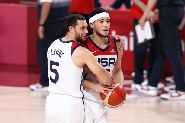 Zach LaVine of the USA Men's National Team hugs teammates Devin Booker after the game against the France Men's National Team during the Gold Medal...