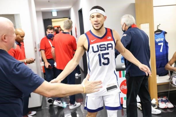 Devin Booker of the USA Men's National Team high fives Athletic Trainer Will Sevening of the USA Men's National Team after defeating the France Men's...