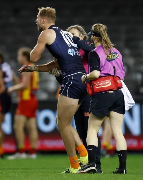 Harry McKay of the Blues speaks with medical staff during the 2021 AFL Round 21 match between the Carlton Blues and the Gold Coast Suns at Marvel...